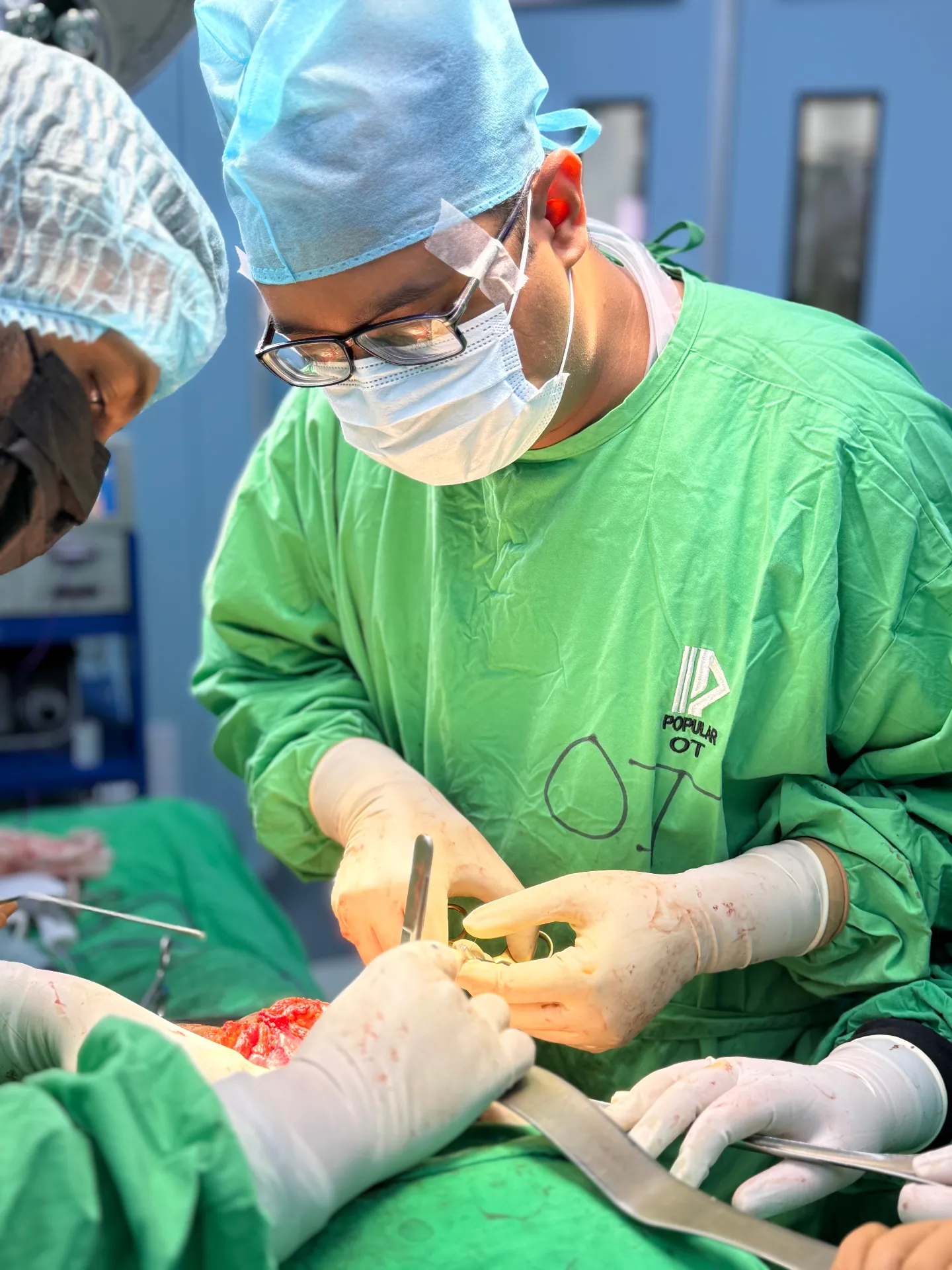 Dr. Murshidul Arefin performing open surgery suturing