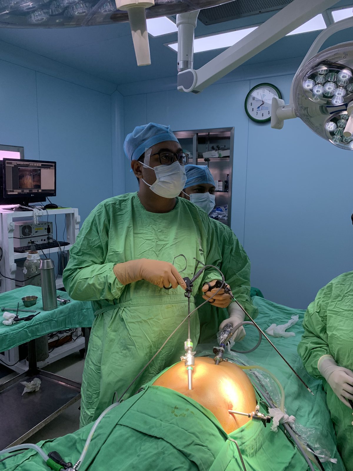 Surgical team performing laparoscopic bile duct obstruction treatment in a modern operating theatre.