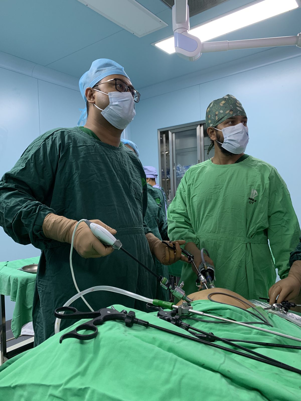 Surgical team performing laparoscopic bile duct surgery in a modern operating theatre.
