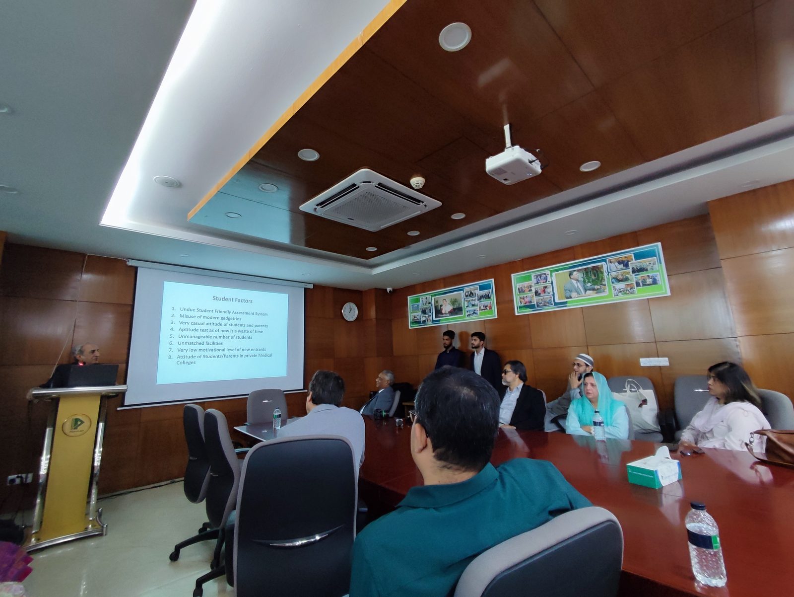 A speaker presenting a slide to attendees during a medical lecture about complex hepatic resection techniques.